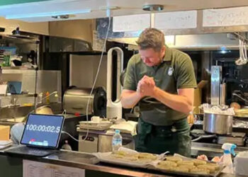 Hilda Baci congratulates Alan Fisher over world record