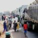 Residents of Akure overpower truck driver, loot rice, beans and garri branded in Tinubu’s name